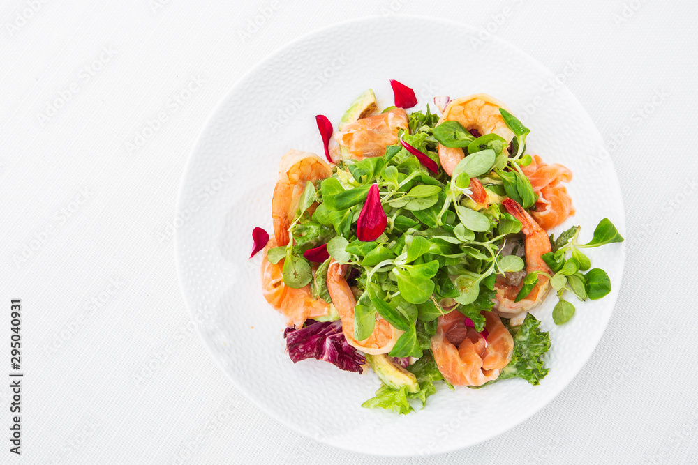 Healthy Salad. Recipe for fresh seafood. Grilled shrimps, prawns, fresh salad lettuce and avocado slices. Healthy Eating. White background. Horizontal photo. Healthy Salad. Recipe for fresh seafood. Grilled shrimps, prawns, fresh salad lettuce and avocado slices. Healthy Eating. White background. Horizontal photo.