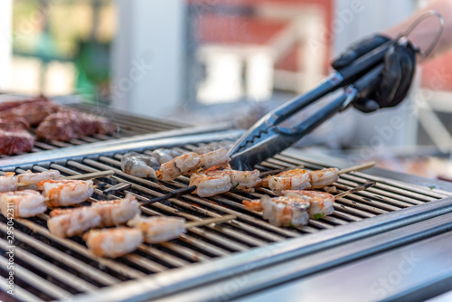 Grilling shrimps on the barbecue in a restaurant during a wedding