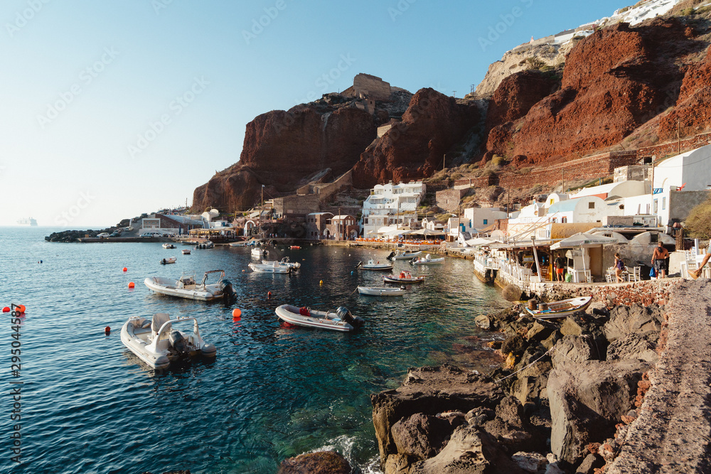 The small coastal fishing village of Amoudi Bay, in Santorini, Greece. Beautiful tiny village at the base of the Oia cliff face. 