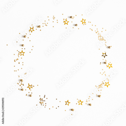 Christmas composition. Christmas golden confetti on white background. Flat lay, top view, copy space