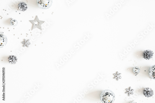 Christmas composition. Christmas silver decorations on white background. Flat lay, top view, copy space