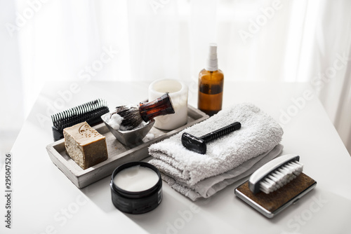 Man care accessory for shaving and grooming on a clean white background, flat lay, top view © seligaa