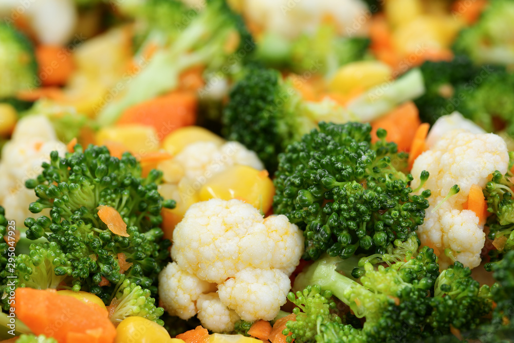 Extreme close up of healthy salad with broccoli, cauliflower, carrot and sweet corn. Selective focus, shallow depth of field. Colorful macro food background