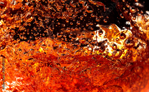 Alcoholic drink on a dark background, abstract splashing.