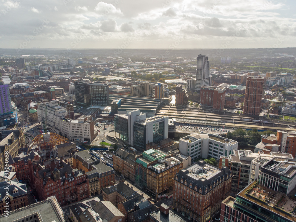 Obraz premium Aerial photo taken on the centre of Leeds in the UK, showing the typical British town centre along with hotels, businesses and shopping centres, taken on a bright sunny part cloudy day