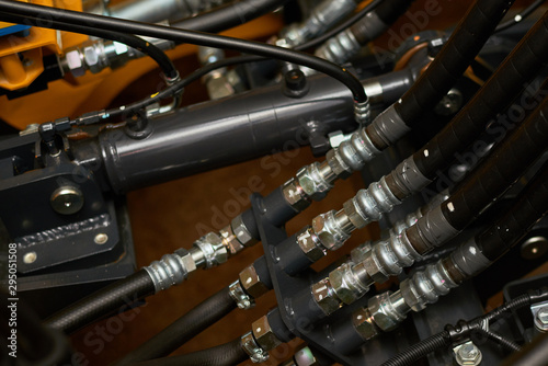 Close up view of hydraulic pipes of heavy industry machine. Low key. © Denys Yelmanov 