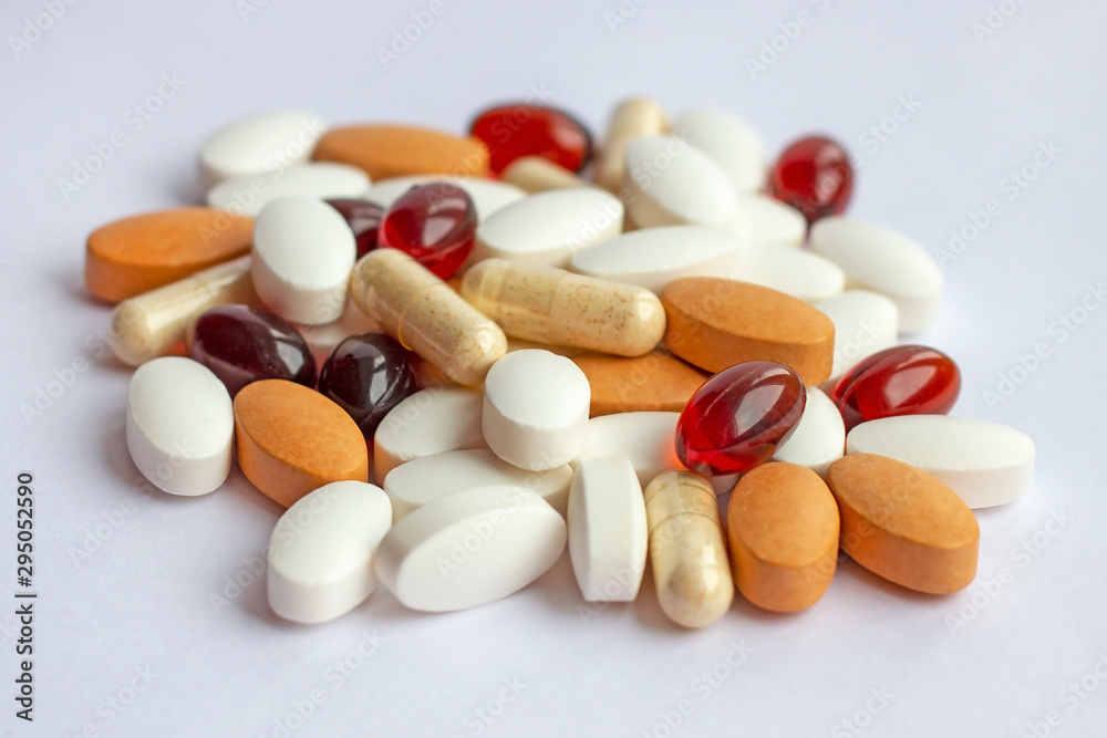 Many different pharmaceutical medicine pills, tablets and capsules on white background. Pharmacy theme, health care, drug prescription for treatment medication and medicament Many different pharmaceutical medicine pills, tablets and capsules on white background. Pharmacy theme, health care, drug prescription for treatment medication and medicament