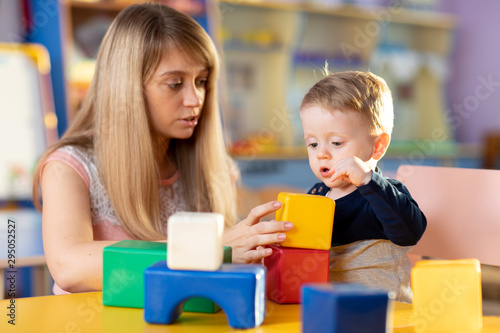 young mother and child playing color blocks together at home