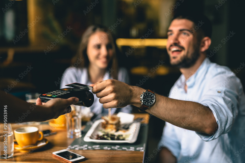 man paying bill at fancy restaurant