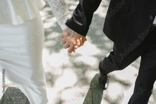 Groom hold bride for her hand and they walk © andriychuk