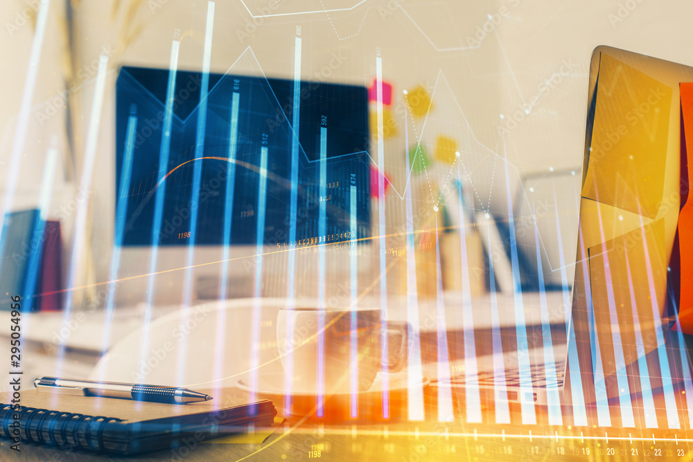 Forex market graph hologram and personal computer on background. Multi exposure. Concept of investment. Forex market graph hologram and personal computer on background. Multi exposure. Concept of investment.