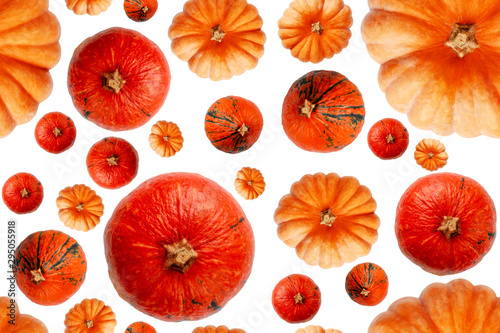 Seamless pattern with pumpkins of different sizes and shapes. Abstract background. Multicolored pumpkins isolated on white background. Top view