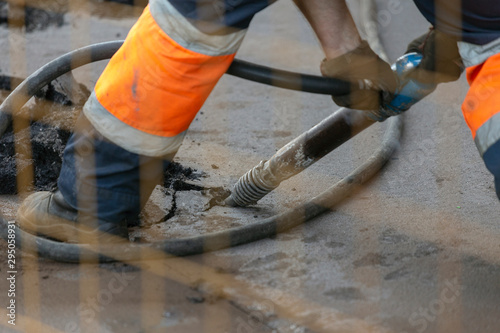 Cutting asphalt for repair with a hammer. road works; horizontal orientation