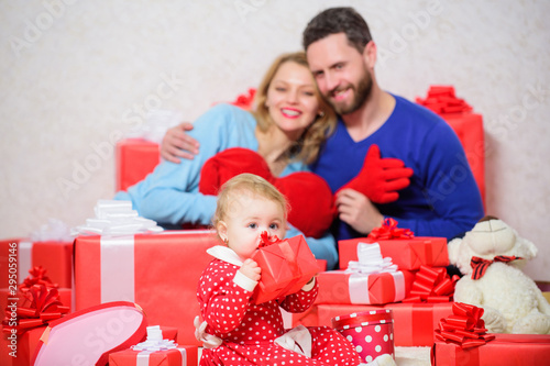 Romantic mood. Shopping. Boxing day. Happy family with present box. Love and trust in family. Bearded man and woman with little girl. Valentines day. Red boxes. father, mother and doughter child