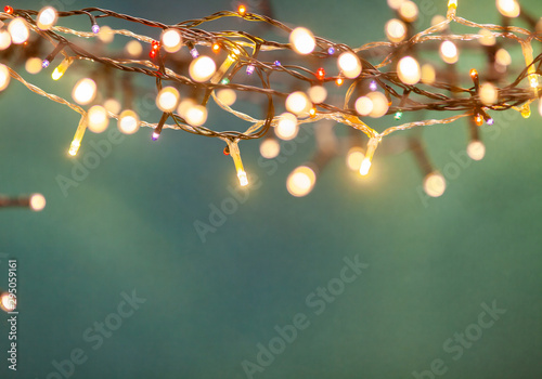 holiday banner of Christmas lights on blue background photo