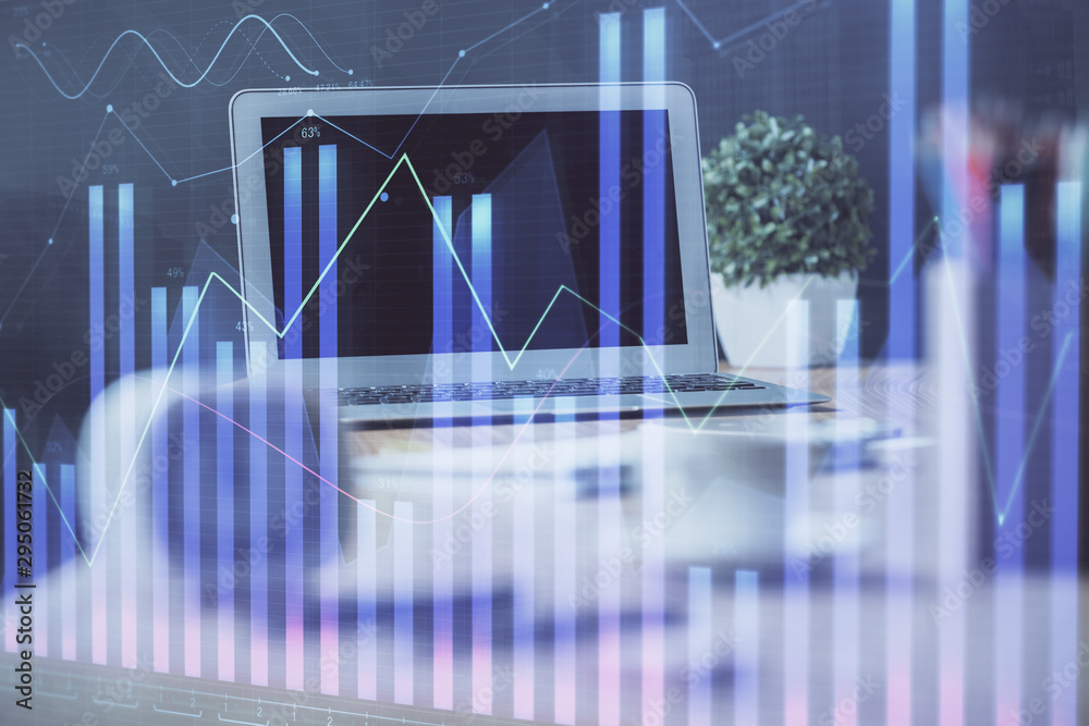 Forex Chart hologram on table with computer background. Multi exposure. Concept of financial markets. Forex Chart hologram on table with computer background. Multi exposure. Concept of financial markets.