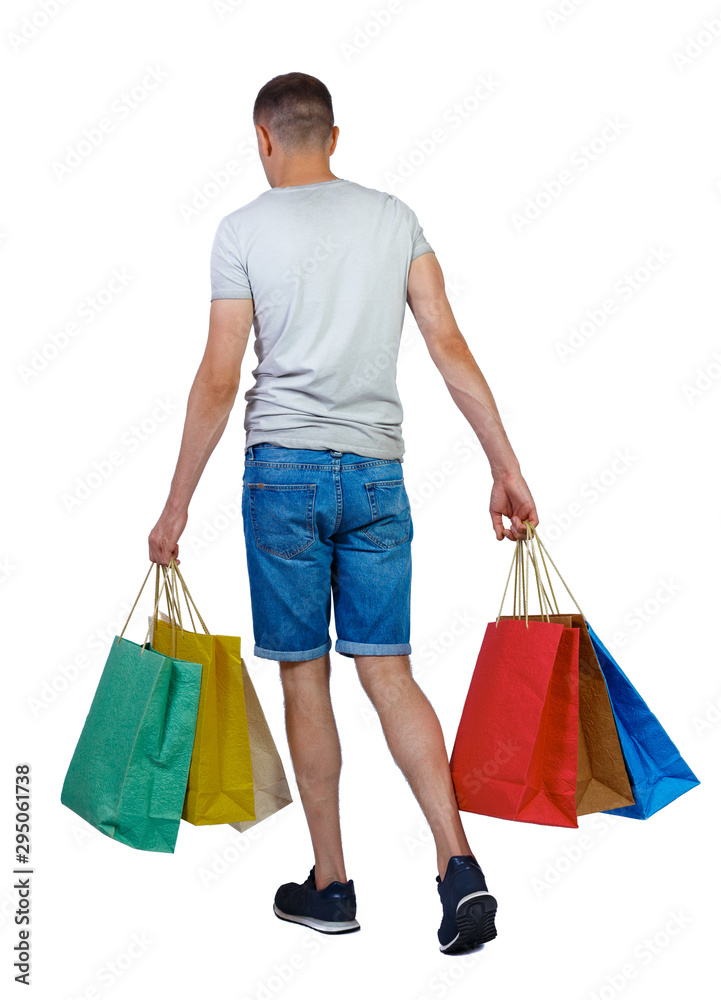 Back view of going man with shopping bags. Back view of going man with shopping bags.