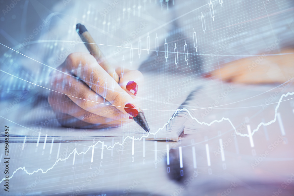 Double exposure of woman's hands making notes with forex graph hologram. Concept stock market analysis. Double exposure of woman's hands making notes with forex graph hologram. Concept stock market analysis.