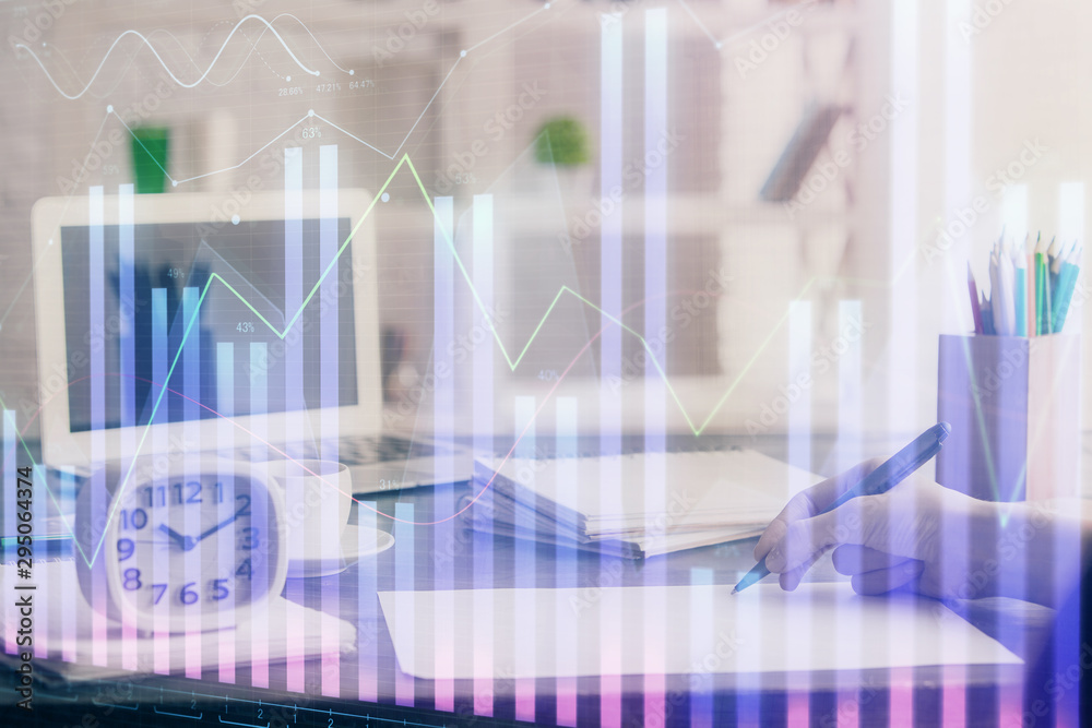 Financial graph displayed on woman's hand taking notes background. Concept of research. Multi exposure Financial graph displayed on woman's hand taking notes background. Concept of research. Multi exposure