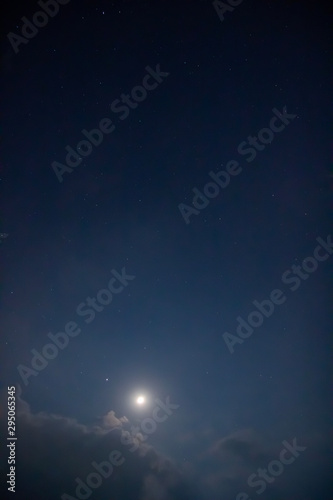 The photos of the moon and star in the night sky covered with clouds.