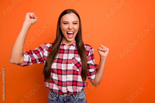 Photo of pretty ecstatic excited cheerful enthusiastic energetic showing her good mood lady holding fists up screaming enjoying first position isolated vivid color background