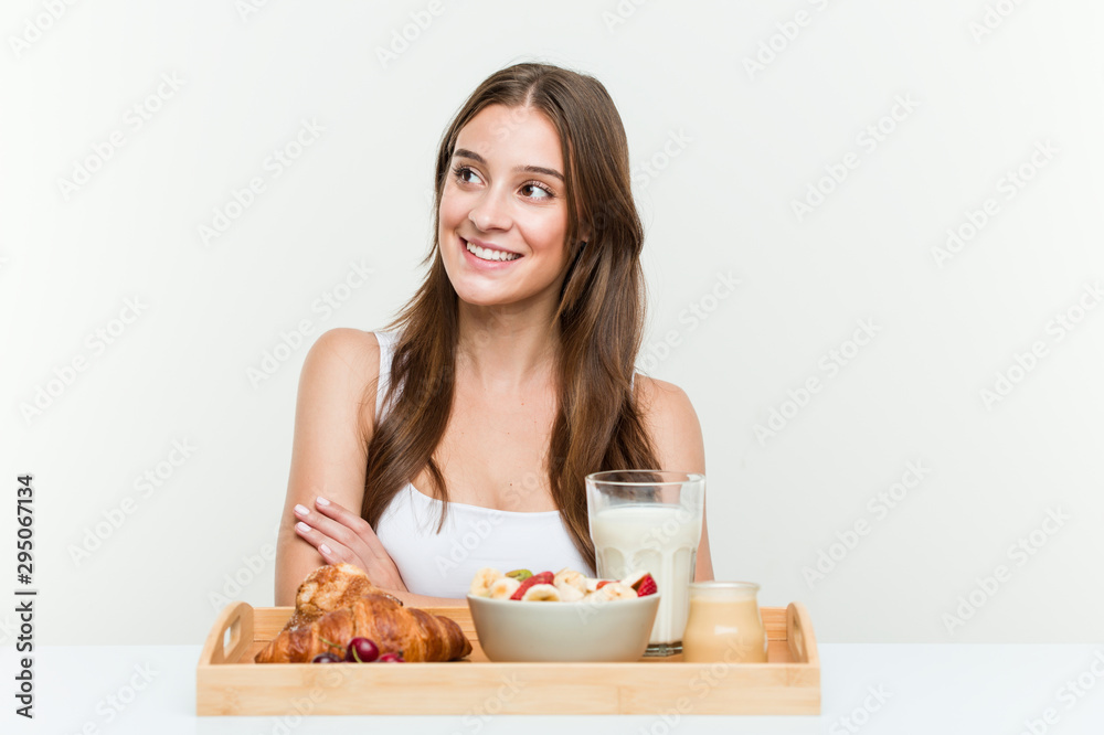 Young caucasian woman having breakfast smiling confident with crossed arms. Young caucasian woman having breakfast smiling confident with crossed arms.