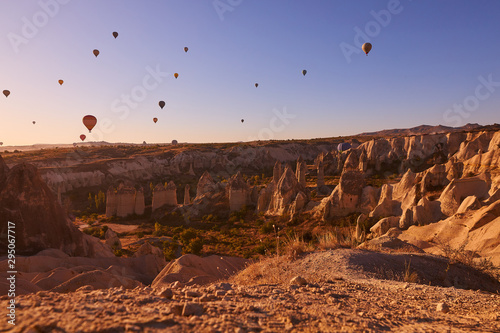 morning photo in Cappadocia with air balloons in the blue sky over sandy hills