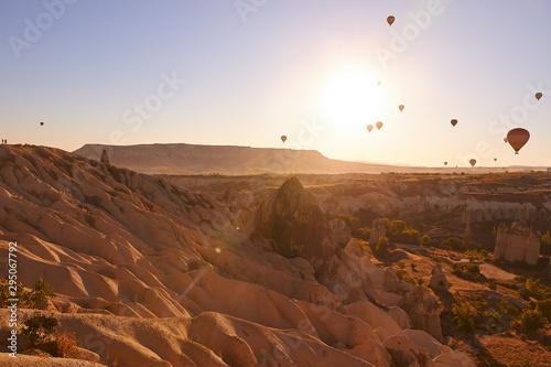 morning photo in Cappadocia with air balloons in the blue sky over sandy hills © monchak