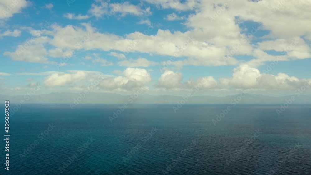 Time lapse. Blue sea and low clouds. Seascape with islands in the distance. The nature of the Philippines. Sea, view from above. Time lapse. Blue sea and low clouds. Seascape with islands in the distance. The nature of the Philippines. Sea, view from above.