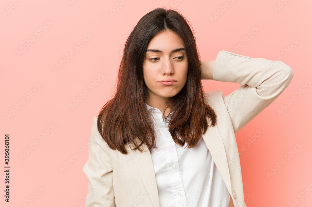 Young brunette business woman against a pink background suffering neck pain due to sedentary lifestyle. Young brunette business woman against a pink background suffering neck pain due to sedentary lifestyle.