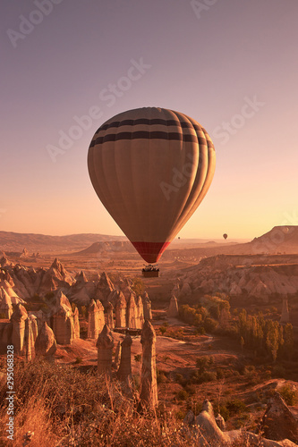 white big air balloon rising in the sky over rocks in Cappadocia