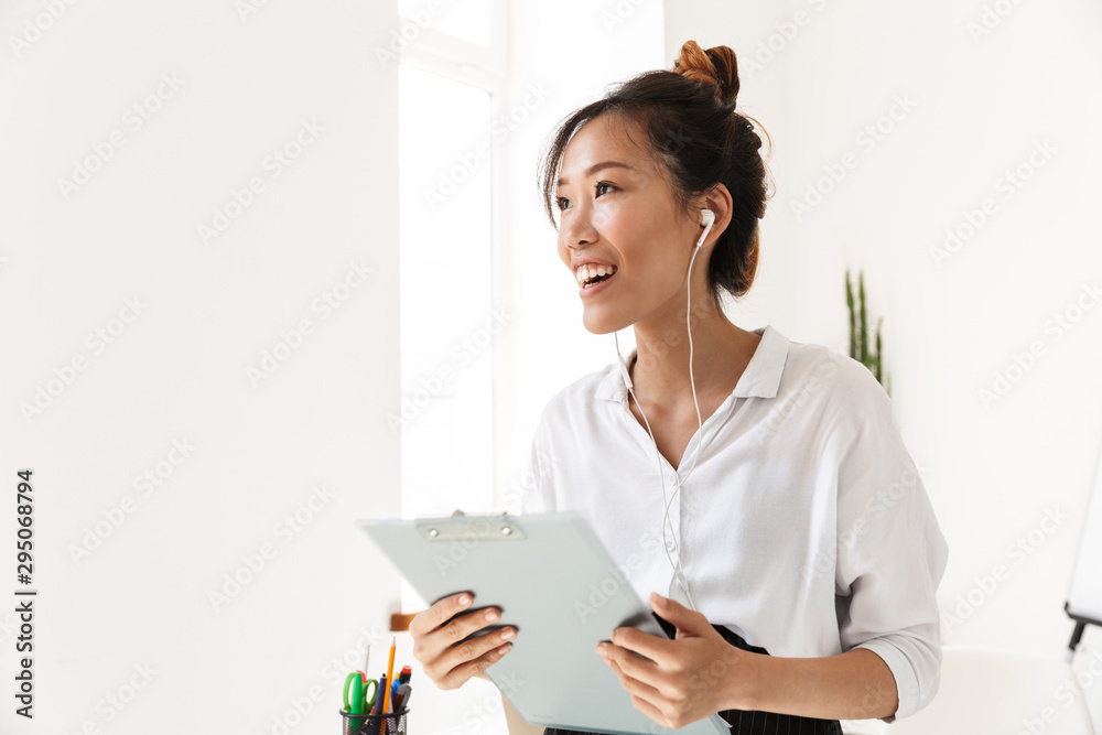 Confident attractive young asian businesswoman standing at her office Confident attractive young asian businesswoman standing at her office