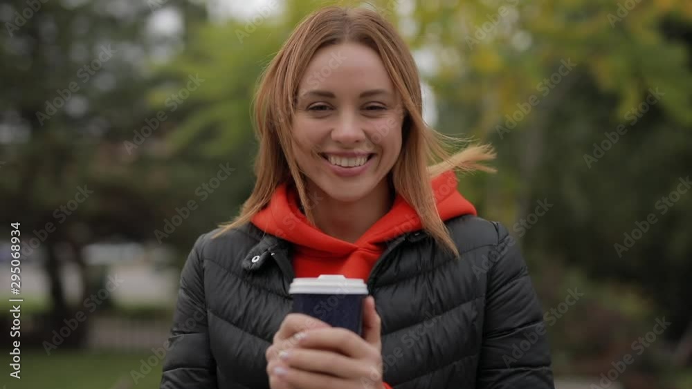 Personal portrait of beautiful smiling woman looking at camera holding cup of coffee outdoor Personal portrait of beautiful smiling woman looking at camera holding cup of coffee outdoor