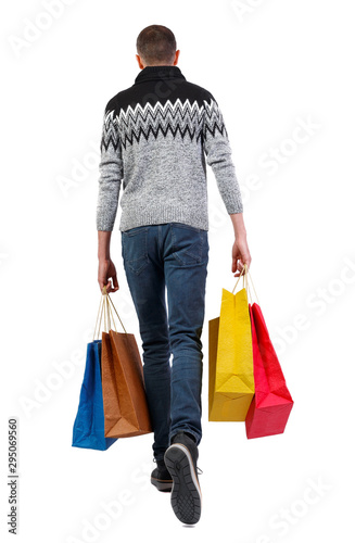 Back view of going man with shopping bags.