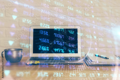 Financial chart drawing and table with computer on background. Multi exposure. Concept of international markets.