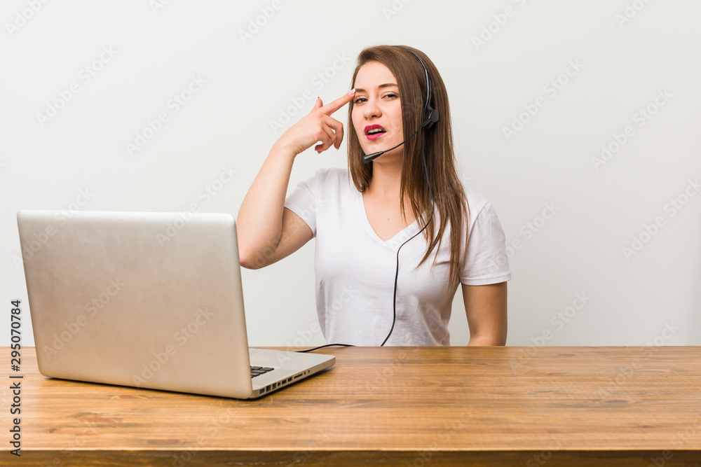 Young telemarketer woman showing a disappointment gesture with forefinger.