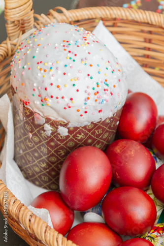 Easter spring cake with painted chicken eggs in a wicker basket