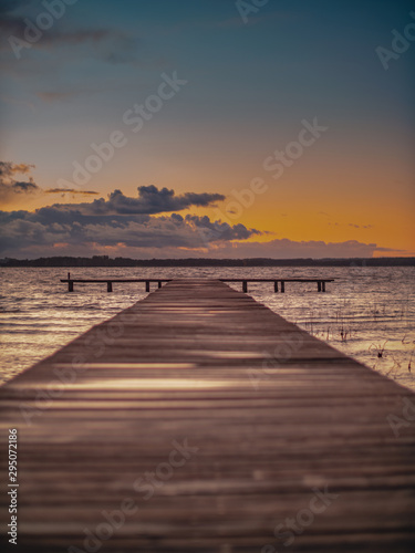 Fototapeta Naklejka Na Ścianę i Meble -  Wooden Lake pier at Sunset