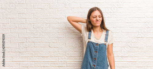 Young hipster woman suffering neck pain