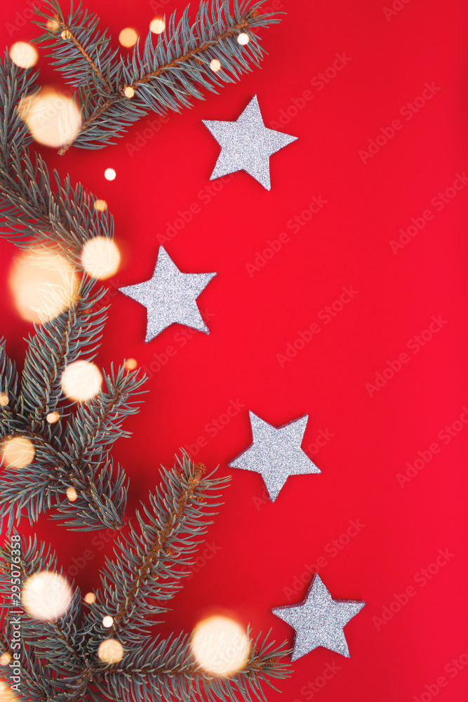 Christmas or New Year decoration background with xmas tree and sparkle bokeh lights and stars. Merry Christmas card. Flat lay, copy space, top view. Space for text.