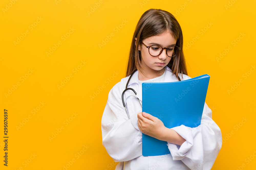 Little caucasian girl wearing a doctor costume Little caucasian girl wearing a doctor costume