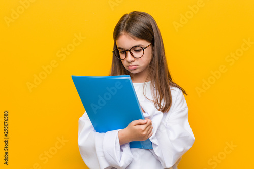Little caucasian girl wearing a doctor costume
