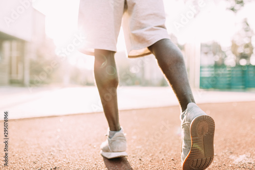 Sports man Jogging, or exercise in the stadium early in the morning