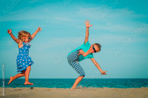 happy boy and girl enjoy playing at beach vacation
