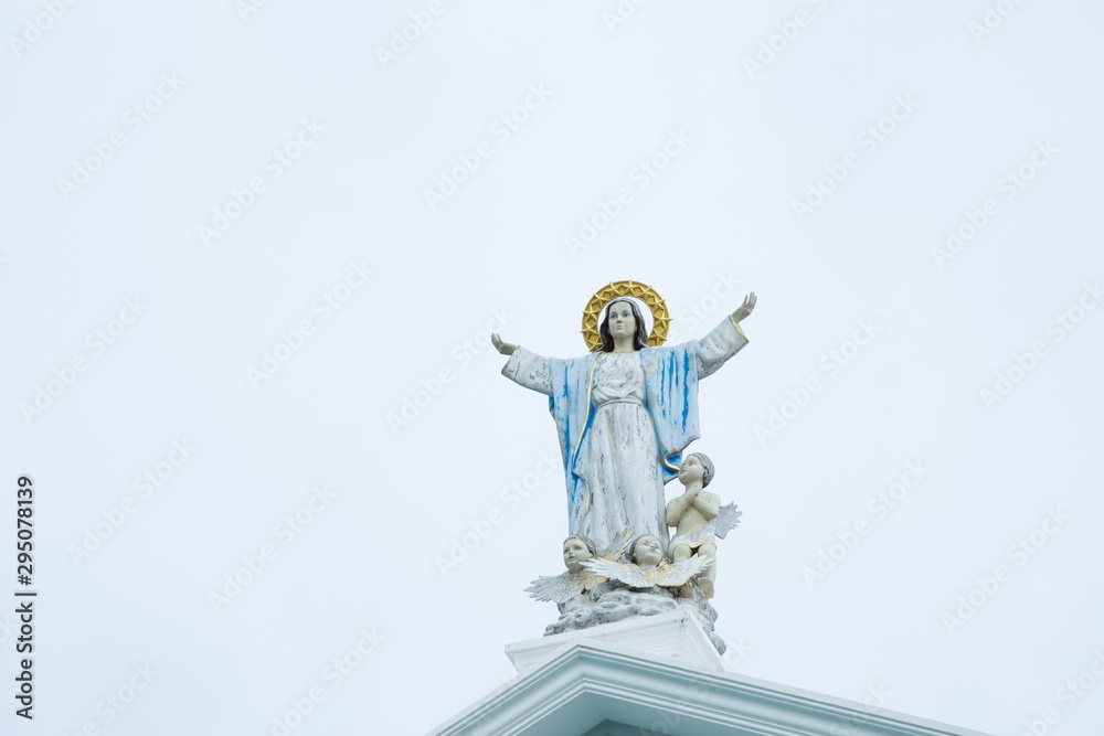 The blessed Mary mother and children , christ catholic god statue on blue sky .
