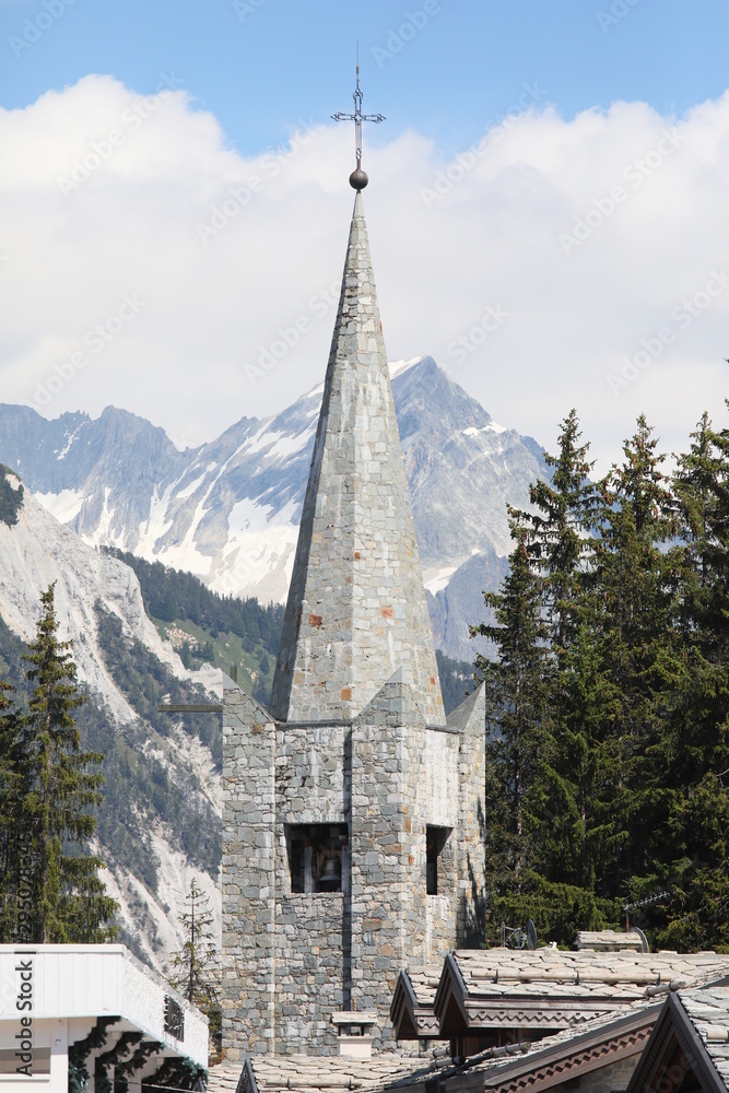 Spire church on an alpine landscape