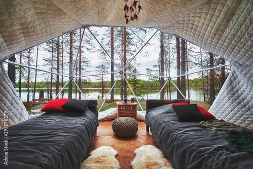 Transparent panoramic window in a big tent with a forest view photo