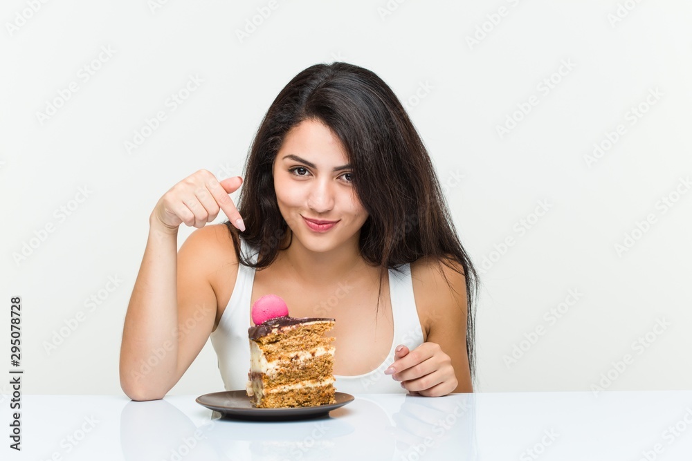 Young hispanic woman eating a carrot cake Young hispanic woman eating a carrot cake