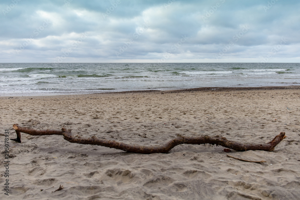 sandy beach by the sea with gloomy cloudy weather
