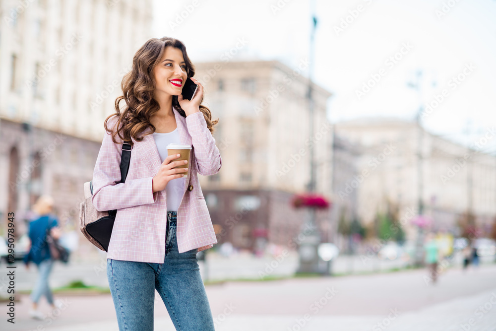 Portrait of her she nice-looking attractive lovely cute cheerful cheery wavy-haired lady foreign tourist making call home discussing adventure landmark sightseeing in downtown center outdoors